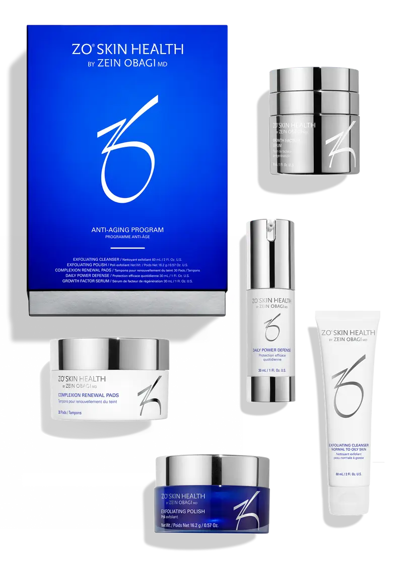 ZO Skin Health by Zein Obagi Anti-Aging Program skincare set featuring a blue and white outer box, a white cream treatment cream jar, a silver pump serum bottle, a white tube of cleanser, and a blue-and-silver powder jar, arranged on a white background.